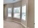 Bright living room featuring a bay window letting in plenty of natural light and neutral carpeting at 473 Cherry Creek Dr, Loganville, GA 30052