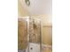 Bathroom featuring a brick-look tile shower with a glass door, and neutral colored walls at 295 Pinehurst Dr, Stockbridge, GA 30281