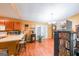 Open-concept kitchen with wood cabinets, a breakfast bar, and hardwood floors at 295 Pinehurst Dr, Stockbridge, GA 30281