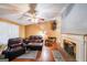 Inviting living room featuring hardwood floors, a classic fireplace, and comfortable leather furniture at 295 Pinehurst Dr, Stockbridge, GA 30281
