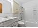 Bright bathroom featuring a shower-over-tub with white tile surround and white wooden vanity cabinet at 655 Sunset Dr, Locust Grove, GA 30248