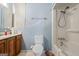 Bathroom featuring a combined shower and tub, single sink vanity and light blue walls at 655 Sunset Dr, Locust Grove, GA 30248