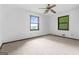 Bedroom showcasing two windows and a ceiling fan for comfortable living at 655 Sunset Dr, Locust Grove, GA 30248