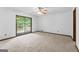 Bedroom featuring carpet flooring and glass sliding doors to a wood deck at 655 Sunset Dr, Locust Grove, GA 30248