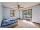 Bedroom with unfinished plywood floor, a window, and sliding glass doors to the backyard at 655 Sunset Dr, Locust Grove, GA 30248