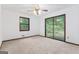 Bedroom featuring carpet, a window, and glass sliding doors to the outside deck at 655 Sunset Dr, Locust Grove, GA 30248