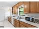 Cozy kitchen featuring wooden cabinets, laminate countertops, and modern appliances at 655 Sunset Dr, Locust Grove, GA 30248