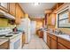 Functional kitchen with wooden cabinets and appliances, ready for a makeover at 655 Sunset Dr, Locust Grove, GA 30248
