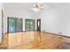Spacious living room featuring hardwood floors, sliding glass doors, and vaulted ceilings at 655 Sunset Dr, Locust Grove, GA 30248