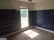 Bedroom with built in shelving, neutral carpet, and a bright window at 390 Burg Rd, Locust Grove, GA 30248