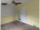 Bedroom featuring a beige carpet, yellow walls, and a closet at 390 Burg Rd, Locust Grove, GA 30248