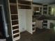 Spacious kitchen area with ample cabinet space and a microwave, ready for renovation at 390 Burg Rd, Locust Grove, GA 30248