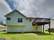 Exterior view of the back of the home, featuring a deck and a well-maintained lawn under a cloudy sky at 426 Summer Hill Cir, Stockbridge, GA 30281