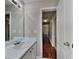 Bathroom has a long vanity with a mirror, sink, and door to the hallway at 426 Summer Hill Cir, Stockbridge, GA 30281