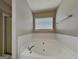 Bathroom featuring a soaking tub, a glass door, and a large window at 426 Summer Hill Cir, Stockbridge, GA 30281