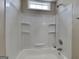 Bathroom showcasing a tub and shower combination with built-in shelves, complemented by neutral wall colors at 426 Summer Hill Cir, Stockbridge, GA 30281