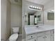 Bathroom featuring a vanity, toilet, and large mirror with modern lighting at 426 Summer Hill Cir, Stockbridge, GA 30281
