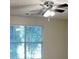 Bright bedroom with ample natural light, a ceiling fan, and serene backyard views at 426 Summer Hill Cir, Stockbridge, GA 30281