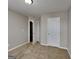 Neutral bedroom showcasing carpeted flooring, a ceiling light, and a closed closet door at 426 Summer Hill Cir, Stockbridge, GA 30281