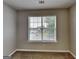 Neutral bedroom showcasing carpeted flooring, a window with blinds, and a light fixture at 426 Summer Hill Cir, Stockbridge, GA 30281