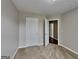 Neutral bedroom showcasing carpeted flooring, a closed closet door, and a white door leading to the hallway at 426 Summer Hill Cir, Stockbridge, GA 30281
