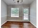 Cozy dining room with hardwood floors, natural light, and a door that leads to a backyard patio at 426 Summer Hill Cir, Stockbridge, GA 30281
