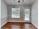 Dining room featuring hardwood flooring, a window, and a chandelier at 426 Summer Hill Cir, Stockbridge, GA 30281