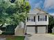 Charming home featuring a two-car garage and a welcoming front porch with stairs at 426 Summer Hill Cir, Stockbridge, GA 30281