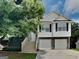 Inviting two-story home featuring a two-car garage and a charming stairway leading to the front door at 426 Summer Hill Cir, Stockbridge, GA 30281