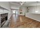 Open-concept living room with hardwood floors, a stone fireplace, and ample space for entertaining guests at 426 Summer Hill Cir, Stockbridge, GA 30281