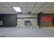 A stone fireplace in the basement, flanked by dark wood paneling and a paneled ceiling at 550 Hawthorne Dr, Fayetteville, GA 30214