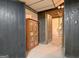 Basement area with dark wood paneling, a vintage bookshelf and an open doorway to the utility area at 550 Hawthorne Dr, Fayetteville, GA 30214