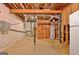 Exposed basement area featuring the home's utilities with concrete flooring, and exposed wooden support beams at 550 Hawthorne Dr, Fayetteville, GA 30214
