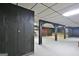 Open basement with a stone bar, dark wood paneling, and a paneled ceiling at 550 Hawthorne Dr, Fayetteville, GA 30214