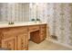 Elegant bathroom featuring a wooden vanity, a marble countertop, and a decorative wallpaper design at 550 Hawthorne Dr, Fayetteville, GA 30214