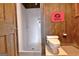 Cozy bathroom featuring a walk-in shower with white walls and a toilet next to the wall with wood paneling at 550 Hawthorne Dr, Fayetteville, GA 30214