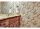 Vintage bathroom showcasing a vanity with floral wallpaper at 550 Hawthorne Dr, Fayetteville, GA 30214
