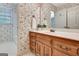 A vanity with wooden drawers and cabinet doors add contrast to a floral bathroom at 550 Hawthorne Dr, Fayetteville, GA 30214