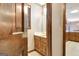 Cozy bathroom with a vanity, sink, and patterned wallpaper at 550 Hawthorne Dr, Fayetteville, GA 30214