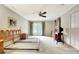 Expansive bedroom featuring natural light, a ceiling fan, and access to a private balcony at 550 Hawthorne Dr, Fayetteville, GA 30214