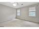 Spacious bedroom with carpet flooring, neutral walls, and two windows for natural light at 550 Hawthorne Dr, Fayetteville, GA 30214