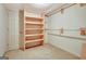 A walk-in closet with built-in shelves and hanging rods maximizes storage space at 550 Hawthorne Dr, Fayetteville, GA 30214