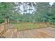 Spacious wooden deck with decorative railings overlooking a lush, wooded backyard at 550 Hawthorne Dr, Fayetteville, GA 30214