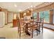 Inviting dining room features a chandelier, wood table, six chairs and large window with a scenic view at 550 Hawthorne Dr, Fayetteville, GA 30214