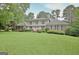 Attractive two-story home featuring a brick facade, lush lawn, and a second story balcony at 550 Hawthorne Dr, Fayetteville, GA 30214