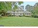 Charming two-story home with a well-manicured lawn, brick accents and a second story balcony at 550 Hawthorne Dr, Fayetteville, GA 30214
