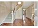 The foyer features hardwood floors, stairs to the upper level, and a chandelier at 550 Hawthorne Dr, Fayetteville, GA 30214