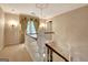 Hallway featuring white banisters, natural light, and decorative wall accents at 550 Hawthorne Dr, Fayetteville, GA 30214