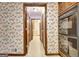 Bright hallway featuring patterned wallpaper, and access to other rooms in the house at 550 Hawthorne Dr, Fayetteville, GA 30214