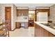 Bright kitchen with light counters, wooden cabinets, and an open design into the dining room at 550 Hawthorne Dr, Fayetteville, GA 30214